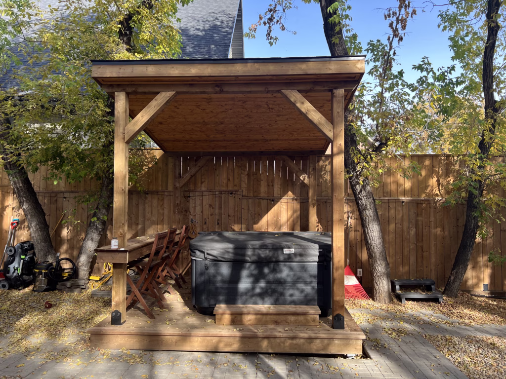 wood patio cover built over hot tub with built in bar area